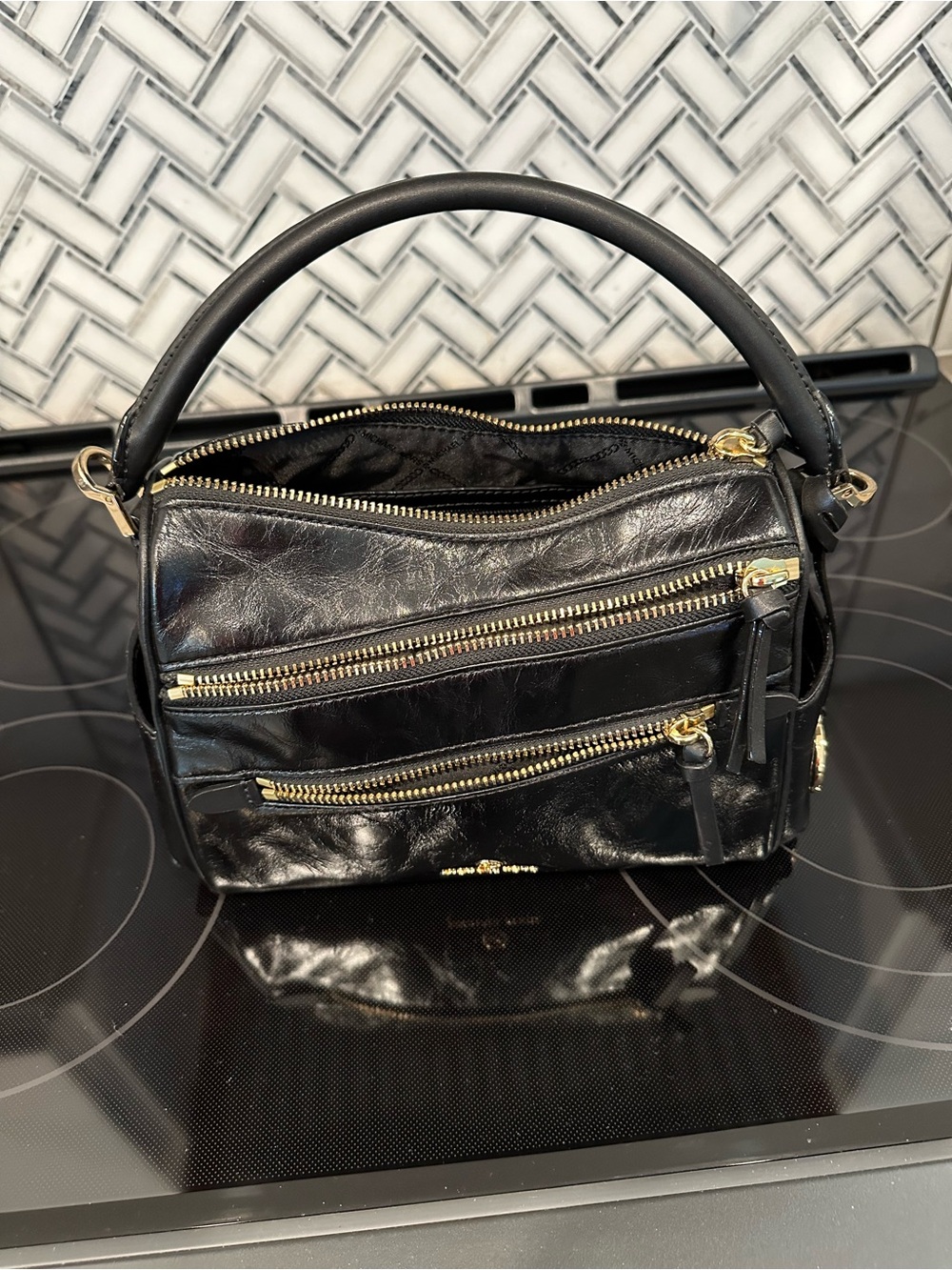 Michael Kors Lorimer satchel I. Black leather with gold accents and logo tag.